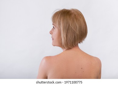 Back View Of Lovely Mature Woman With Nude Body Looking Aside On Light Studio Background, Free Space. Feminine Senior Lady With Soft Silky Skin Taking Care Of Herself. Beauty And Wellness Concept