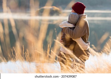 back view of lovely young couple hugging in winter - Powered by Shutterstock