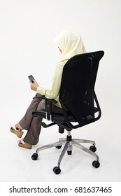 Back View Of Malay Business Womanusing Her Hand Phone