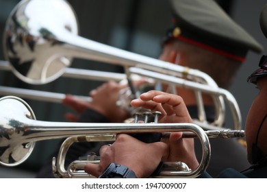 Back View Of Male Army Musicians Performing A Trumpet Show. At An Outdoor Jazz Event