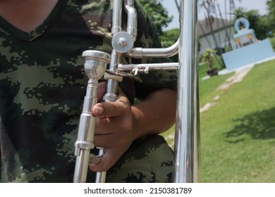 Back View Of Male Army Musicians Performing A Trumpet Show. At An Outdoor Jazz Event