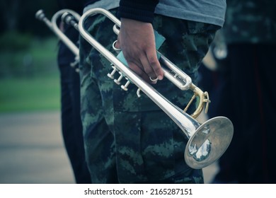 Back View Of Male Army Musicians Performing A Trumpet Show. At An Outdoor Jazz Event