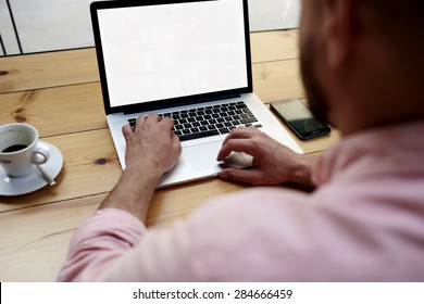 Back View Of Male Person Sitting Front Open Laptop Computer With Blank Empty Screen For Your Information Or Content, Modern Businessman Working In Internet Via Notebook,student At Coffee Shop Learning