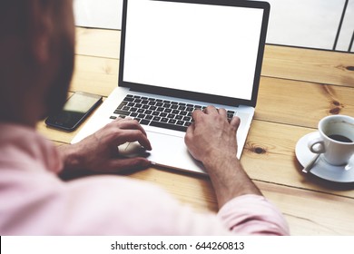 Back View Of Male Person Sitting Front Open Laptop Computer With Blank Empty Screen For Your Information Or Content, Modern Businessman Working In Internet Via Notebook,student At Coffee Shop Learning