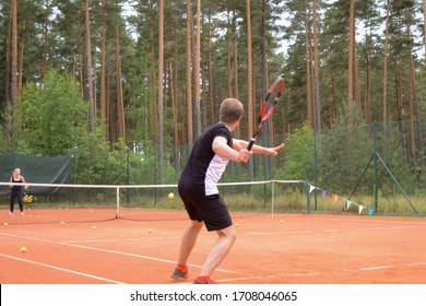 Back View Of A Male Tennis Player With A Racket Waiting For A Pass From The Opponent