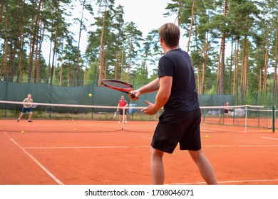 Back View Of A Male Tennis Player With A Racket In Action