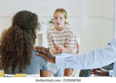 Back View Of Male Therapist Supporting Teenage Girl In Mental Health Therapy Holding Hand On Shoulder