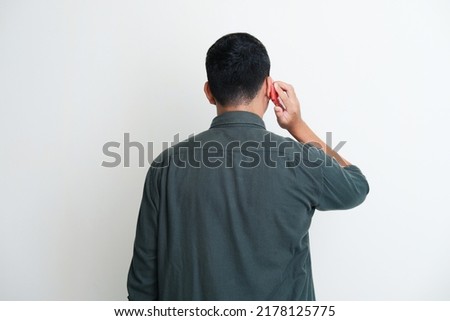 Back view of a man answering mobile phone call