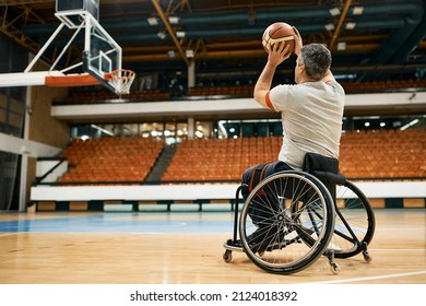 Back View Of Man With Disability Taking A Shoot During Basketball Training.