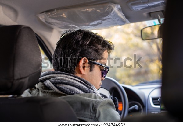 A back view of man driving\
a car