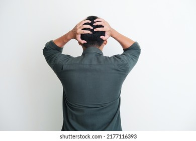 Back view of a man grabbing his head showing stress gesture - Shutterstock ID 2177116393