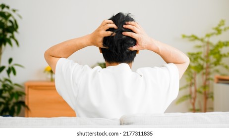 Back View Of Man Holding His Head	