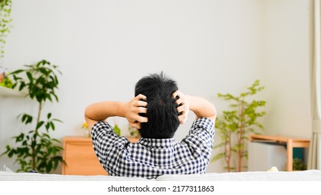 Back View Of Man Holding His Head	