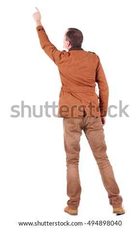 Back view of  man in jacket  pointing. Young handsome guy in jeans and  jacket showing. Rear view people collection.  backside view of person.  Isolated over white background.