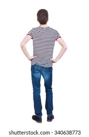 Back View Of Man In Jeans. Standing Young Guy. Rear View People Collection.  Backside View Of Person.  Isolated Over White Background. The Guy In The Striped Shirt With Hands On Hips Standing.