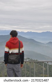 Back view of a man looking to mountains while standing outdoors 