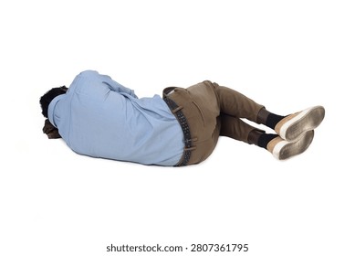 back view of a man lying on the floor in the fetal position
