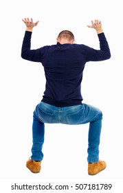 Back View. Man  Protects Hands From What Is Falling From Above. Man Holding A Heavy Load Backside View Person.  Isolated Over White Background. A Guy In A Black Sweater, Sat Down Under The Weight Load