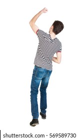 Back View Of  Man.  Raised His Fist Up In Victory Sign.   Rear View People Collection.  Backside View Of Person.  Isolated Over White Background. 