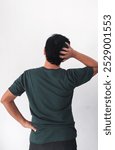 back view of man, Rear view of adult asian man scratching his head showing confused gesture. Back view of Indonesian man with confused gesture and scratching head.