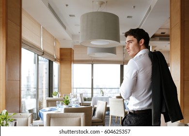 Back View Of Man In Shirt Which Walking In Restaurant And Looking Away