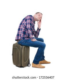 Back View Man Sitting On Suitcase. Waiting At Station. Backside View Person.  Rear View People Collection. Isolated Over White Background. Guy With Travel Bag On Wheels Looking At Something At Top