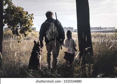 back view man standing in field with kid and german shepherd dog, post apocalyptic concept