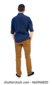 Back view of man . Standing young guy. Rear view people collection.  backside view of person.  Isolated over white background.a man in a blue shirt with the sleeves rolled up, standing with his hands