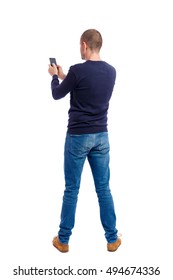 Back View Of Man In Suit  Talking On Mobile Phone.    Rear View People Collection. Isolated Over White Background. Backside View Of Person. Man In Black Warm Sweater Keeps Both Hands Free.