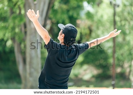 Back view of a man taking a deep breath