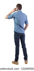 Back View Of A Man Talking On The Phone. Backside View Of Person.  Rear View People Collection. Isolated Over White Background. A Man In A Shirt Is Standing Holding A Smartphone To His Ear.