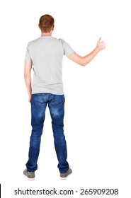 Back view of  man in t-shirt. shows thumbs up.   Rear view people collection.  backside view of person.  Isolated over white background.