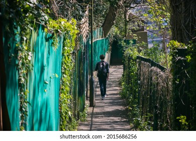 Back view of a man walking down an alleyway alone in Archway, London, England