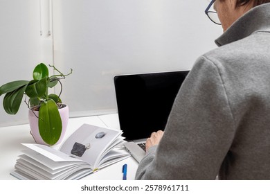 back view of a man while he is studying in his office