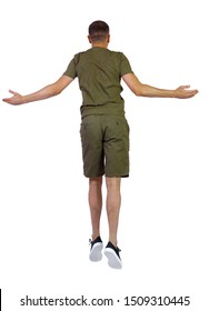 Back View Of Man In Zero Gravity Or A Fall. Guy Is Flying, Falling Or Floating In The Air.  Side View Of Person. Isolated Over White Background. A Guy In Shorts Is Hanging In The Air With His Arms Out