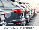 Back view many modern new SUV cars fleet stock at dealership parking lot. Automobile market production factory industry warehouse. Auto salvage buy and sell auction purchase seller platform