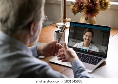 Back view of mature man have webcam digital virtual conference conversation with grownup son. Elderly father talk speak on video call with adult millennial male child. Online communication concept. - Powered by Shutterstock