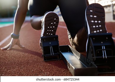 Back view of men's feet on starting block ready for a sprint start - Shutterstock ID 684725344