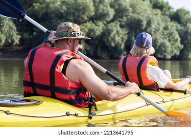 Back View Of Middle Age Couple Kayaking In A Tandem Kayak In Danube River At Summer Morning