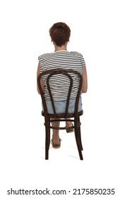 Back View Of Middle Aged Woman Sitting Legs On Chair Legs Crossed On White Background