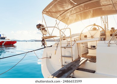 Back view modern luxury sailboat in turquoise sea ocean water marina bay harbor. Sail boat rental charter berth docking service. Nautical adventure travel lifestyle. Cruise trip vacation - Powered by Shutterstock