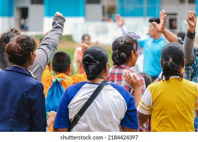 Back View Of Moms Watch And Cheering Their Sons Playing Football In School Tournament On Sideline. Sport, Outdoor Active,  Spectator Watching Soccer Game. Parents Care And Encourage Their Children.