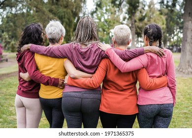 Back view of multi generational women having fun together outdoors in city park - Main focus on african woman head - Powered by Shutterstock