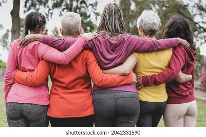 Back view of multi generational women hugging each other outdoor - Multiracial people and teamwork concept - Powered by Shutterstock