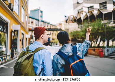 Back View Of Multicultural Tourists Dressed In Casual Wear Walking On Streets In Urban Street Of New City During Weekend's Trip.Couple In Love Exploring And Enjoying Showplaces During Travel Tour