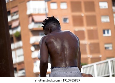 Back View Of A Muscular Black Boxer With A Sweaty Back After An Outdoor Boxing Fitness Workout. Boxing And Training Concept 2021. 