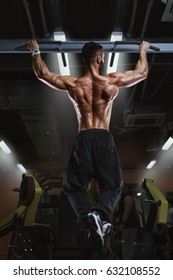 Back View Of Muscular Man Doing Pull Up Exercise