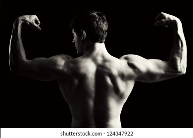 Back view of a muscular young man in black and white. - Powered by Shutterstock