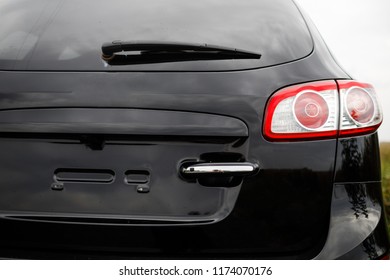 Back view of new black car. Closeup headlights of car. Black premium city crossover, luxury SUV rear light closeup. Car lamp close-up.
