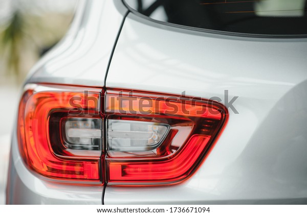 Back view of new white car. Closeup headlights\
of car. White premium city crossover, luxury SUV rear light\
closeup. Car lamp\
close-up.